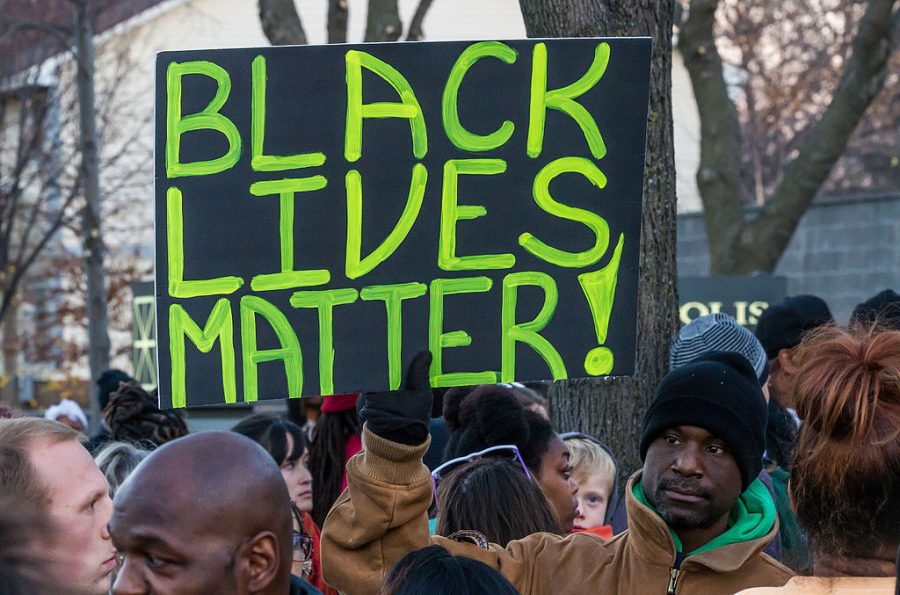 poster at a protest that reads BLACK LIVES MATTER!